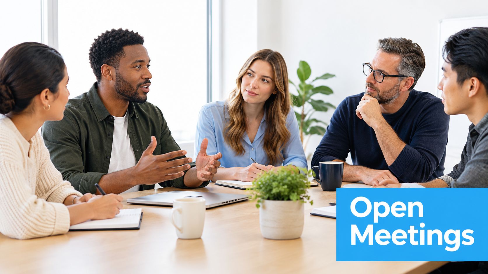 A diverse group of professionals sitting around a wooden table in an office for a business meeting.